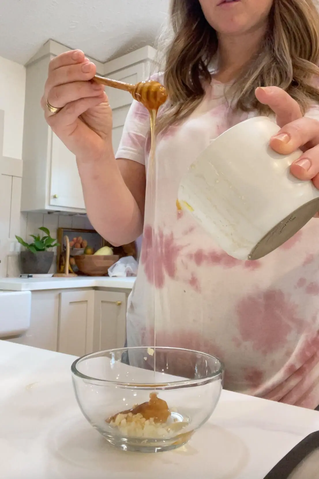 Homemade natural remedy being prepared with raw honey and garlic, perfect for sore throat and immunity.